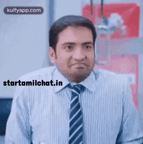 A Man In A Striped Shirt And Tie Making A Funny Face GIF