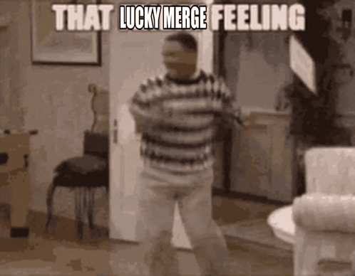 A Man In A Striped Shirt Is Dancing In A Living Room . GIF