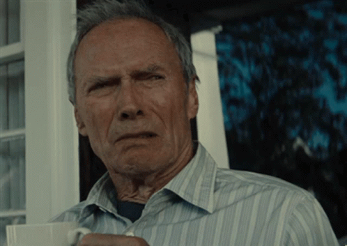 A Man In A Striped Shirt Is Holding A Cup GIF