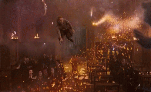 a man in a striped shirt is jumping in the air in front of a crowd