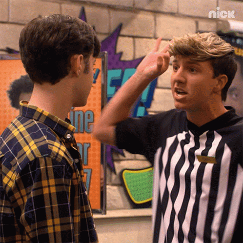 A Man In A Striped Shirt Is Pointing At Another Man In Front Of A Sign That Says ' Nick ' On It GIF