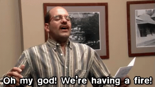 A Man In A Striped Shirt Is Saying Oh My God We 'Re Having A Fire . GIF