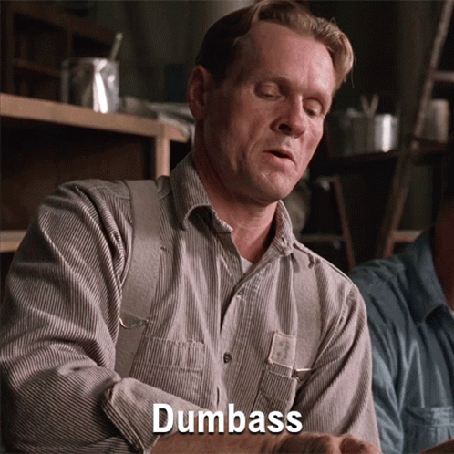 A Man In A Striped Shirt Says Dumbass In Front Of Him GIF