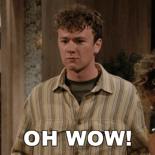 A Man In A Striped Shirt Says " Oh Wow " In White Letters GIF