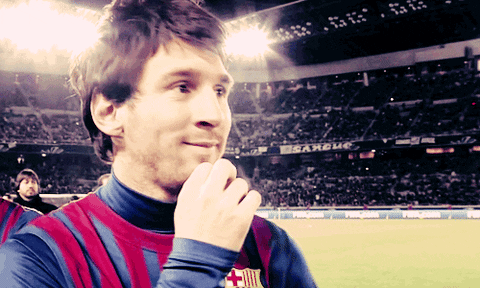 A Man In A Striped Shirt Stands In Front Of A Sign That Says ' Estadio ' On It GIF