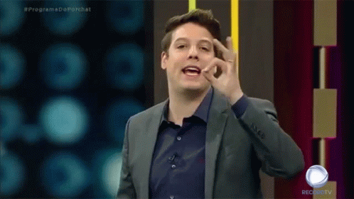A Man In A Suit And A Blue Shirt Is On A Record Tv Show GIF