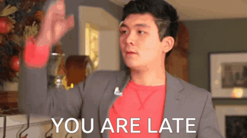 A Man In A Suit And A Red Shirt Says You Are Late GIF