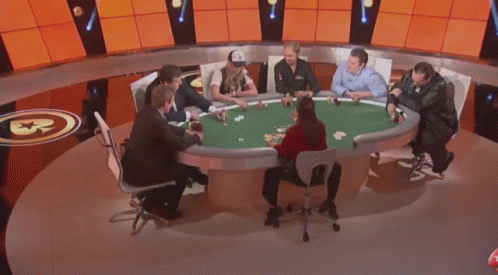 A Man In A Suit And A Woman In A Police Uniform Are Playing Poker . GIF