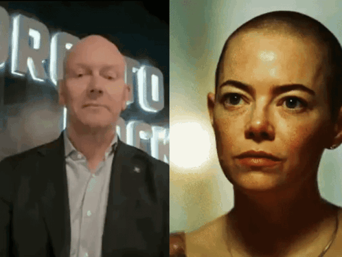 a man in a suit and a woman with a shaved head in front of a sign that says toronto