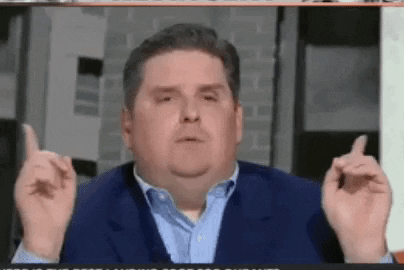 A Man In A Suit And Blue Shirt Is Giving The Middle Finger . GIF