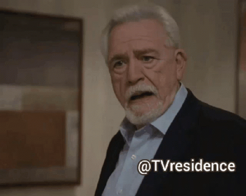 A Man In A Suit And Blue Shirt Is Standing In Front Of A Painting With The Words @Tvresidence Below Him GIF