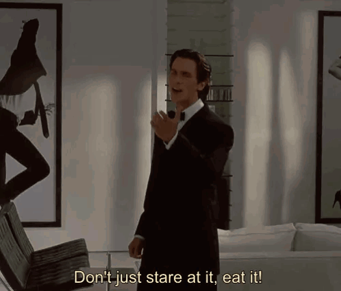 A Man In A Suit And Bow Tie Says " Don 'T Just Stare At It Eat It " GIF