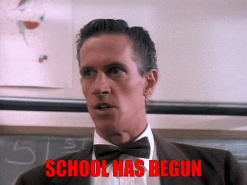 A Man In A Suit And Bow Tie Says School Has Begun In Red GIF
