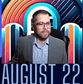 A Man In A Suit And Glasses Is Standing In Front Of A Colorful Background With The Date August 22 . GIF
