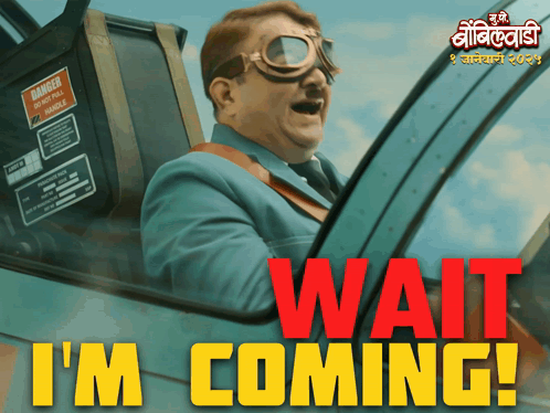 A Man In A Suit And Goggles Is Driving A Car With The Words Wait I 'M Coming In Red GIF