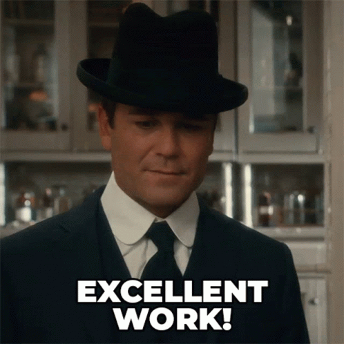 A Man In A Suit And Hat Is Giving An Excellent Work Sign GIF