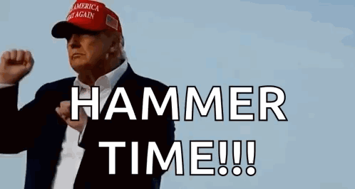 A Man In A Suit And Hat Is Holding His Fist Up In The Air . GIF