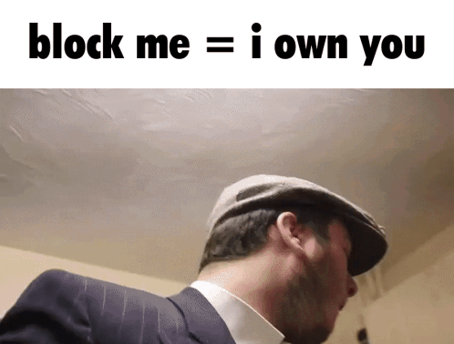 A Man In A Suit And Hat With The Words Block Me = I Own You Above Him GIF