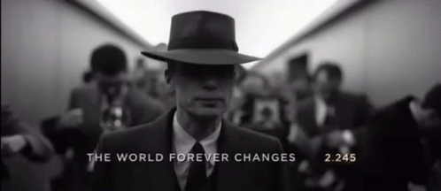 A Man In A Suit And Hat With The Words " The World Forever Changes " On The Bottom GIF