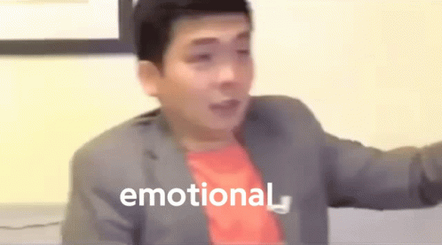A Man In A Suit And Red Shirt Is Making A Funny Face And The Word Emotional Is Visible In The Background . GIF