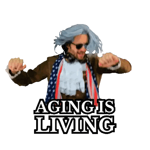 a man in a suit and scarf is dancing with the words aging is living below him