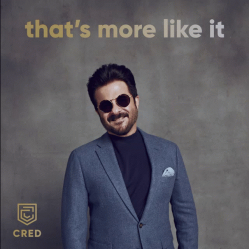 A Man In A Suit And Sunglasses Gives A Thumbs Up With The Words That 'S More Like It Behind Him GIF