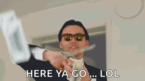 A Man In A Suit And Sunglasses Is Holding A Bunch Of Money In His Hand . GIF