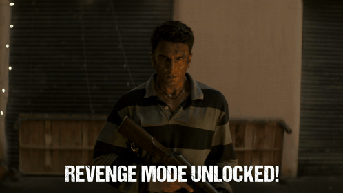 A Man In A Suit And Sunglasses Is Standing In A Hallway With The Words Revenge Mode Unlocked Written Below Him GIF
