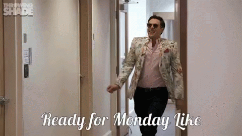 A Man In A Suit And Sunglasses Is Walking Down A Hallway And Saying Ready For Monday Like . GIF
