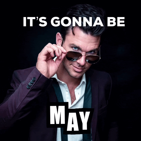 A Man In A Suit And Tie Adjusts His Sunglasses With The Words It 'S Gonna Be May Below Him GIF