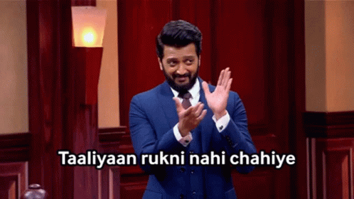 A Man In A Suit And Tie Applauds With The Words Taaliyaan Rukni Nahi Chahiye Above Him GIF