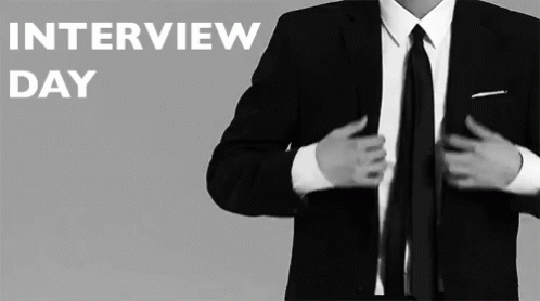 A Man In A Suit And Tie Getting Ready For An Interview Day GIF