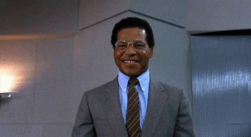 A Man In A Suit And Tie Giving A Thumbs Up GIF