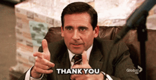 A Man In A Suit And Tie Giving A Thumbs Up With The Words Thank You Below Him GIF