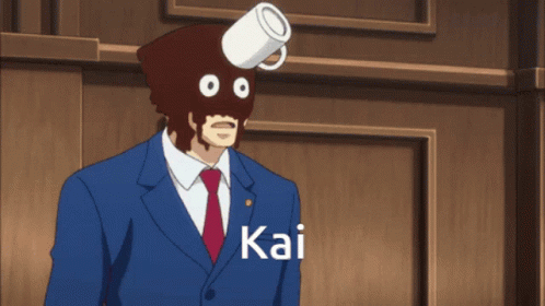 A Man In A Suit And Tie Has A Cup On His Head And The Name Kai Is On The Bottom GIF