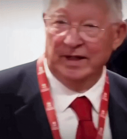 a man in a suit and tie has a lanyard around his neck that says ' lg '