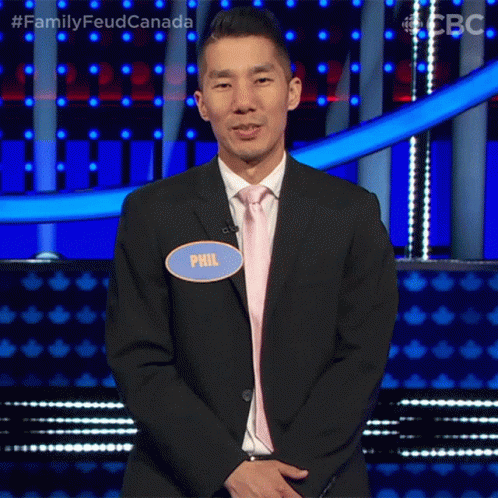 A Man In A Suit And Tie Has A Name Tag That Says Phil On It GIF