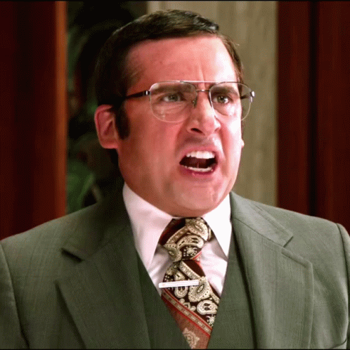 A Man In A Suit And Tie Has A Name Tag That Says ' Steve ' On It GIF