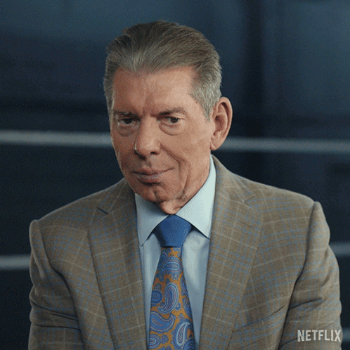 A Man In A Suit And Tie Has A Netflix Logo On His Shoulder GIF