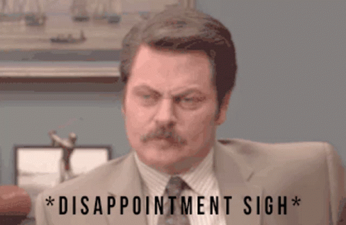 A Man In A Suit And Tie Has Disappointment Sigh Written Below Him GIF