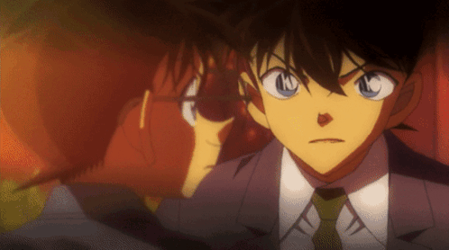 A Man In A Suit And Tie Has The Letter N On His Face GIF