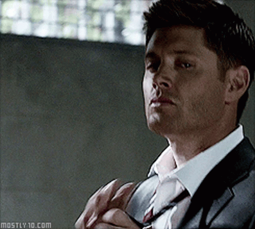 A Man In A Suit And Tie Has The Website Mostly10.com At The Bottom GIF