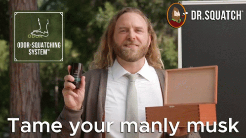 A Man In A Suit And Tie Holding A Bottle Of Odor Squatting System GIF