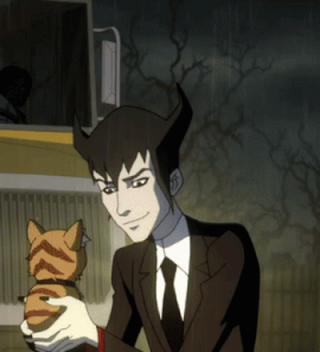 A Man In A Suit And Tie Holding A Cat GIF