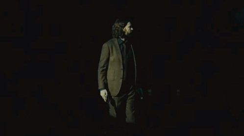 Man In Suit Holding Two Guns GIF