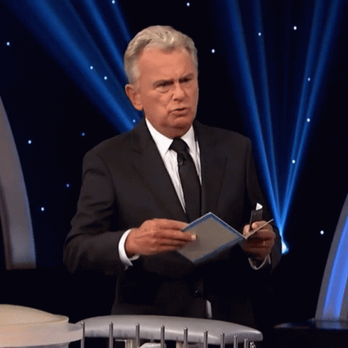 A Man In A Suit And Tie Holds A Box That Says One Million GIF