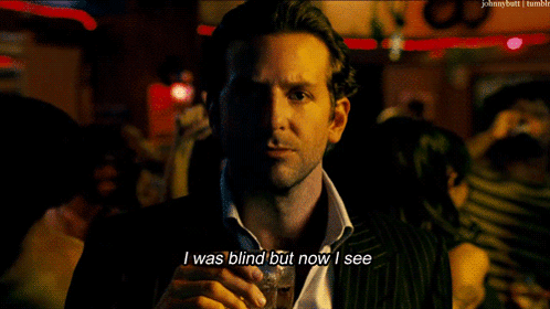 A Man In A Suit And Tie Holds A Glass Of Whiskey And Says I Was Blind But Now I See GIF