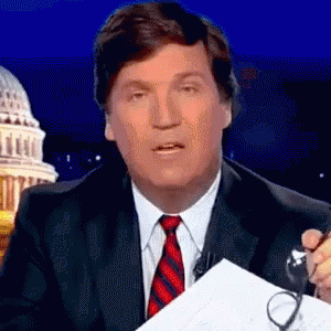 A Man In A Suit And Tie Holds A Pair Of Glasses GIF