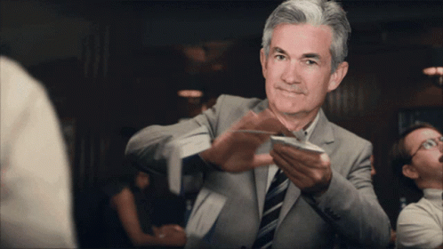 A Man In A Suit And Tie Holds A Piece Of Paper GIF