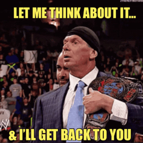 A Man In A Suit And Tie Holds A Wrestling Championship Belt And Says Let Me Think About It GIF